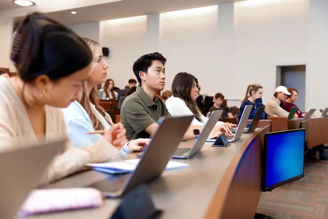 人们在雪城大学的校园里听讲座.